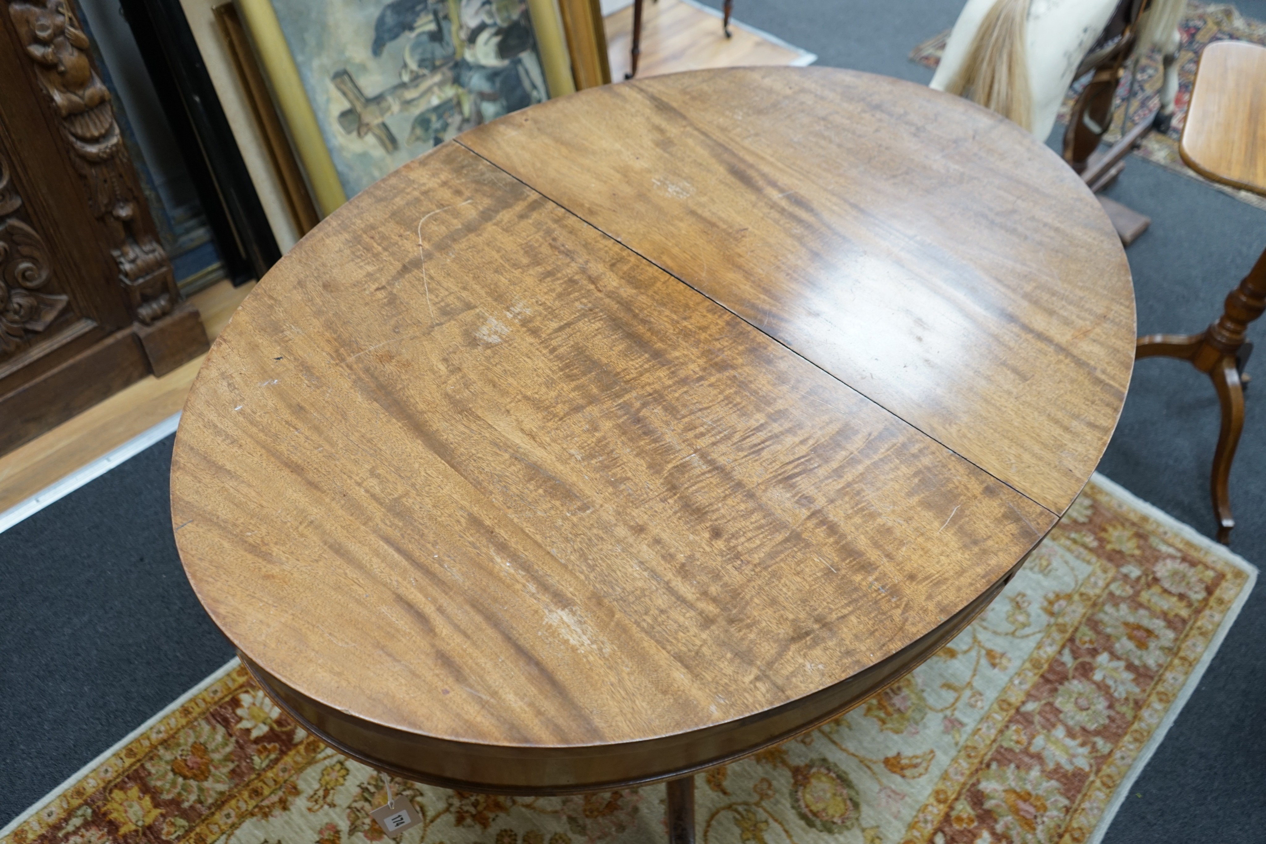 A small George III style oval mahogany extending dining table, (no leaves) width 126cm, depth 91cm, height 77cm